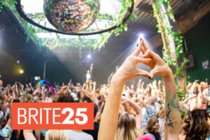 A crowd hold their hands aloft at a Daybreaker event.